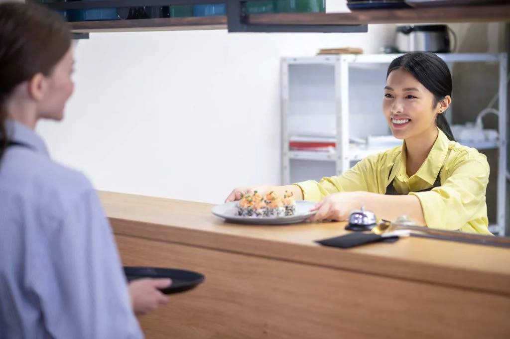 restaurant-asian-waitress-serving-sushi-customer-1-1024x681